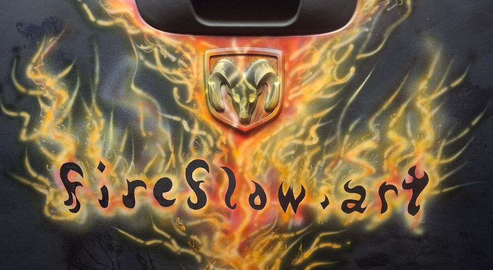 Airbrushed Dodge Ram tailgate — flames, Ram emblem, and fireflow.art lettering